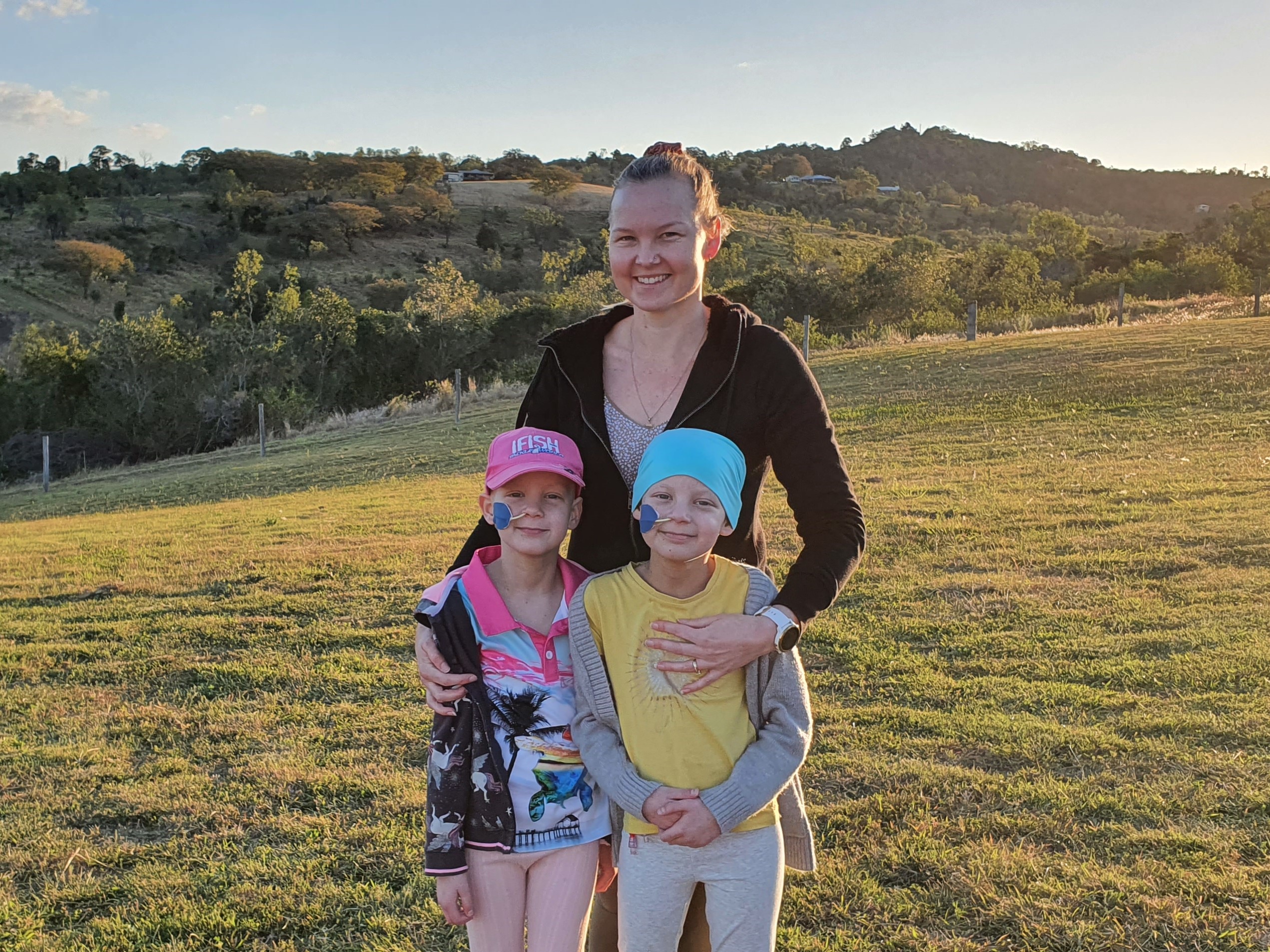 twin girls who both have chronic granulomatous disease pictured with their mother.