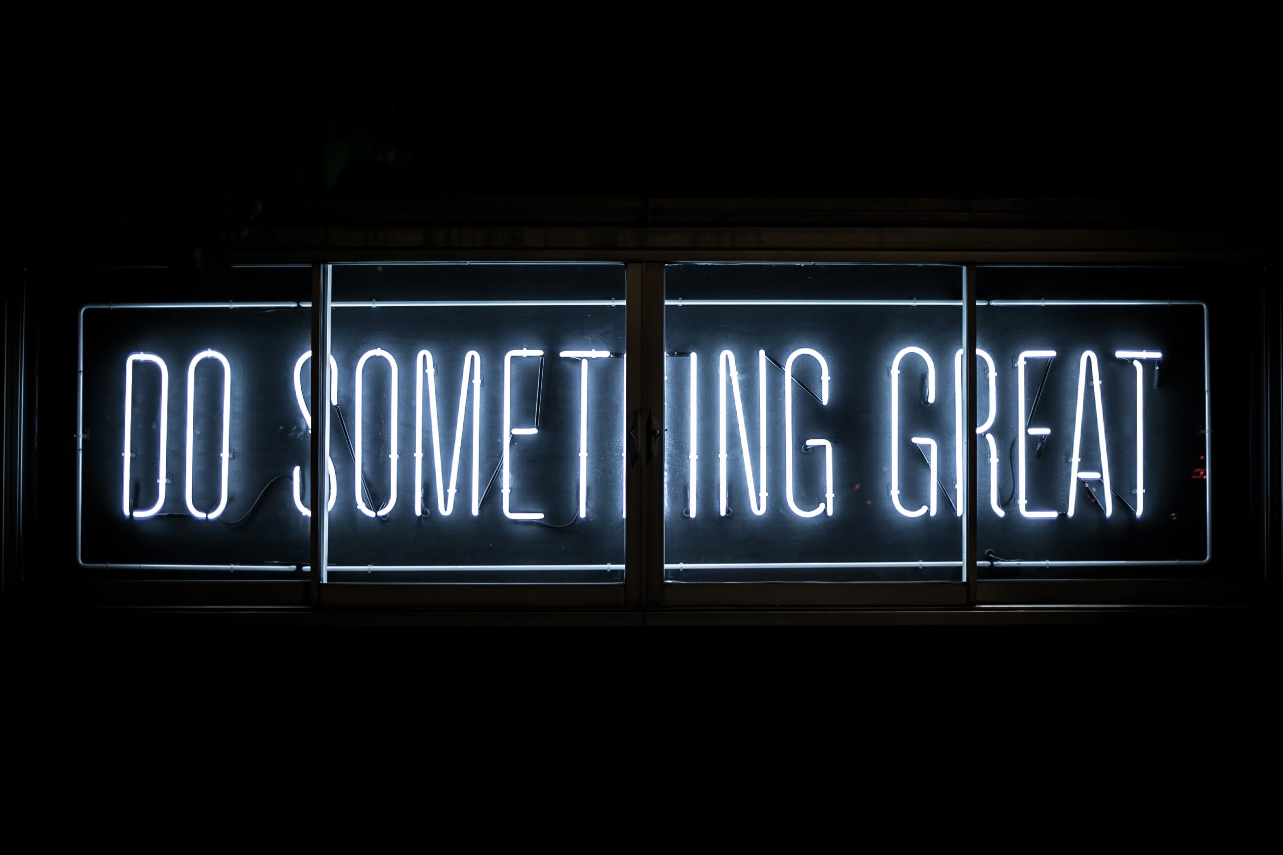 neon sign that reads "do something great"